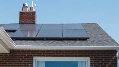 brown brick house with solar panels on roof