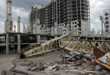 a pile of rubble sitting in front of a tall building