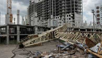 a pile of rubble sitting in front of a tall building