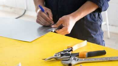 person holding blue and silver scissors