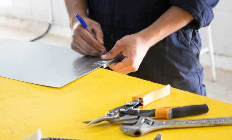 person holding blue and silver scissors