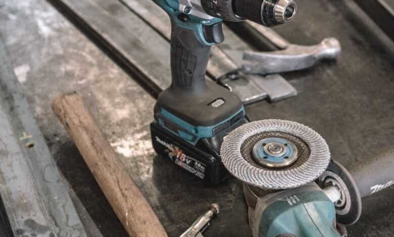 green Makita cordless drill near angle grinder