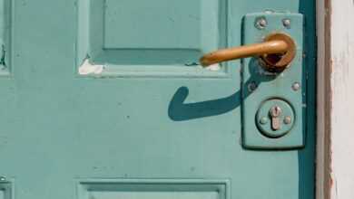 white wooden door with brass door lever