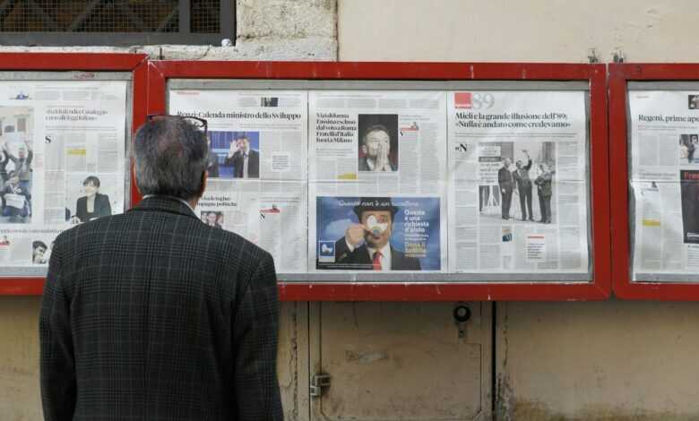 man reading newspaper in bulletin board