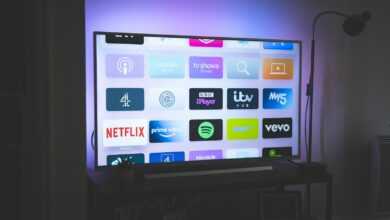black flat screen tv turned on showing game