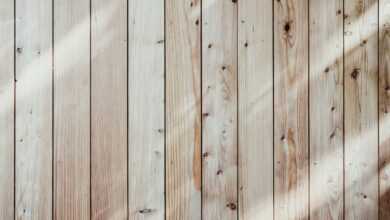 a close up of a wooden wall with a light shining on it