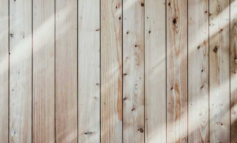 a close up of a wooden wall with a light shining on it