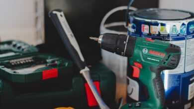 red and black cordless power drill beside black and red cordless power drill